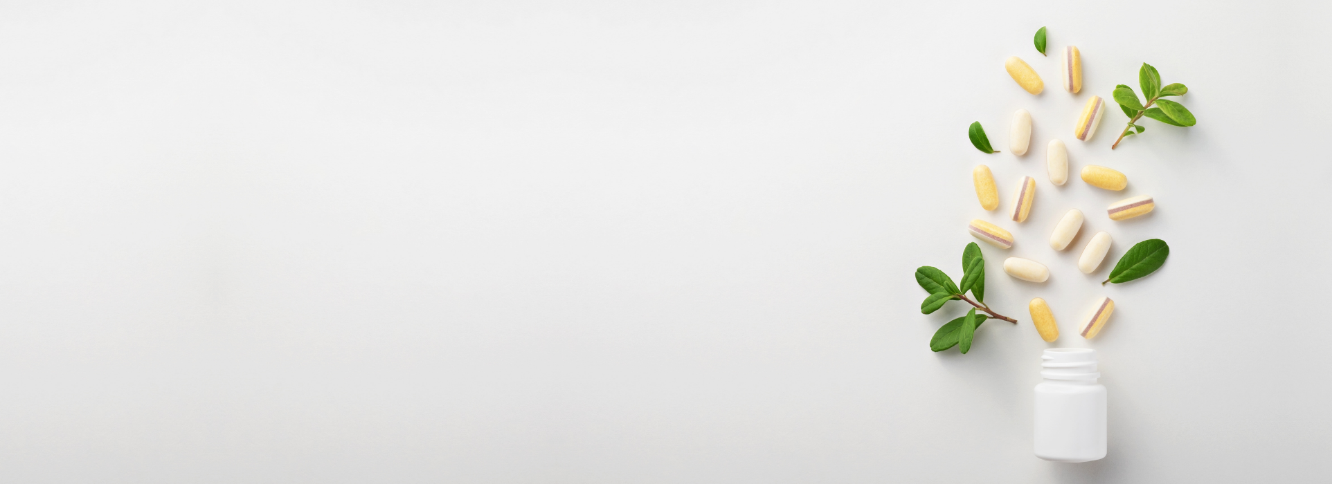 Vitamins and a white bottle on a light gray background